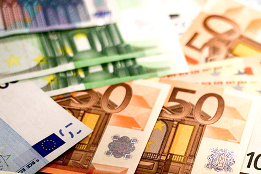 Nahaufnahme mehrerer Euro-Banknoten, darunter 50- und 100-Euro-Scheine, die ausgebreitet sind und sich überlappen.